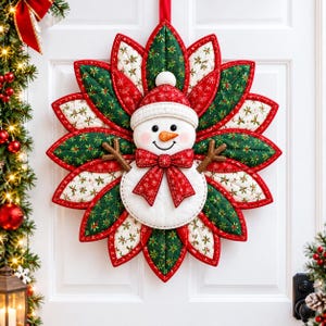 Pode incluir: Uma tapeçaria de tecido acolchoado com um boneco de neve central com nariz de cenoura, usando um chapéu e laço vermelhos, rodeado por pétalas pontiagudas em camadas com padrões alternados de verde e branco com motivos.