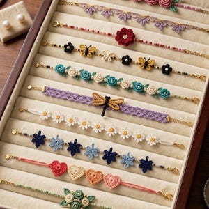 May include: A collection of ten delicate handmade crochet bracelets displayed in a wooden jewelry box. The bracelets feature intricate floral, butterfly, dragonfly, and heart motifs in various colors including pink, blue, yellow, and white.
