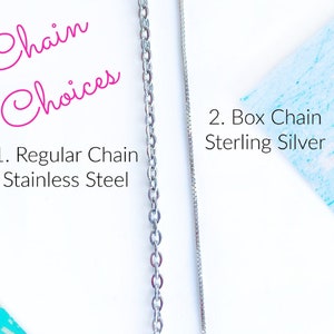 May include: Two silver chains, one regular chain made of stainless steel and one box chain made of sterling silver. The text "Chain Choices" is written in pink cursive above the chains. The text "1. Regular Chain Stainless Steel" is written below the first chain. The text "2. Box Chain Sterling Silver" is written below the second chain.