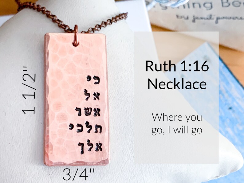 May include: A copper necklace with a rectangular pendant featuring Hebrew text. The pendant measures 1 1/2 inches by 3/4 inches. The necklace is inscribed with the text "Ruth 1:16 Necklace" and the phrase "Where you go, I will go".