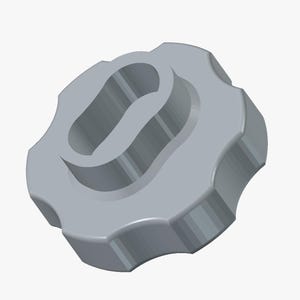 May include: A light grey plastic knob featuring a circular shape with a scalloped, ridged outer edge for grip. The centre of the knob contains a recessed, elongated oval opening with a curved, wave-like divider running through the middle.