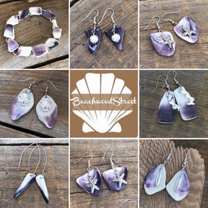 May include: A collection of handcrafted jewelry featuring a bracelet and various earrings. The earrings showcase unique designs with purple and white shell accents, some adorned with starfish or feather charms. The jewelry is displayed on a rustic wooden surface.