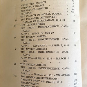 May include: Open book page with a table of contents. The text includes chapter titles and page numbers. Topics include Gandhi, independence, and related historical events. The book appears to be an academic or historical text.