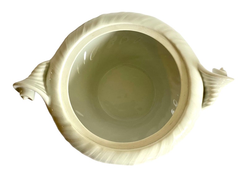 Pu&ograve; includere: Zuppiera in ceramica bianca con due manici decorati. La zuppiera ha un interno liscio e bianco e un esterno testurizzato.