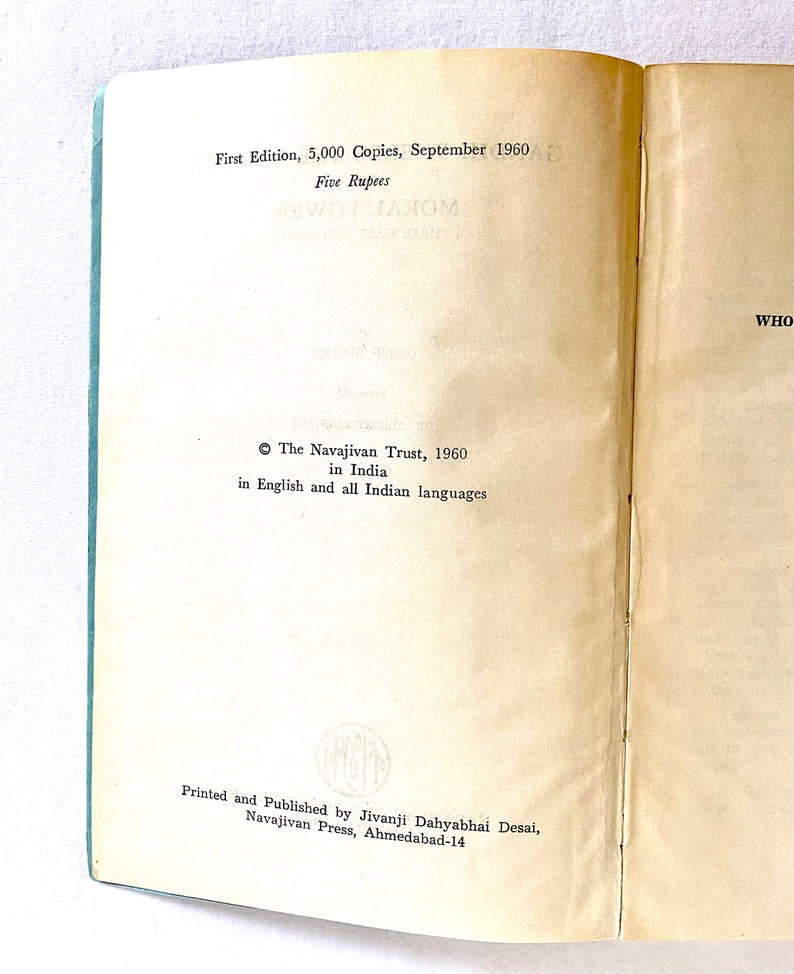 May include: Open book with text from the first edition of a book published in September 1960. The text includes the title, publisher, and price in rupees. The pages are off-white with a light blue spine.