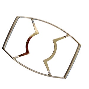 May include: A silver metal jar lid opener with a spring-loaded handle. The opener is designed to easily remove lids from jars.