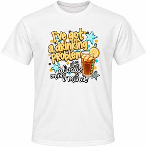 May include: A white short-sleeved t-shirt featuring a graphic print with the text "I've got a drinking problem it's always on my mind" in yellow and black, accompanied by a glass of iced tea with a lemon slice and blue star accents.