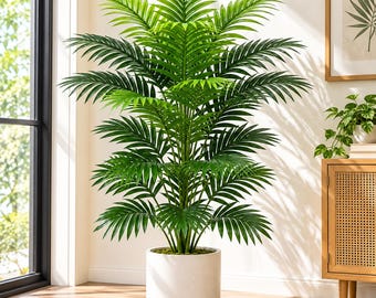 May include: A tall artificial palm plant with vibrant green, feathery fronds arranged in a symmetrical, layered pattern. The plant is housed in a simple, cylindrical white pot with a smooth finish, creating a clean and balanced appearance.