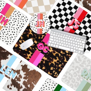 May include: A collection of personalized mouse pads and a coaster with various patterns, including polka dots, checkered, and animal print. The pads feature initials in pink, orange, and blue. A wireless keyboard and mouse are also present.
