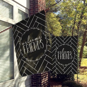 May include: Two black and white welcome flags with a chevron pattern and the text "welcome friends" in a white circle with a wreath design.