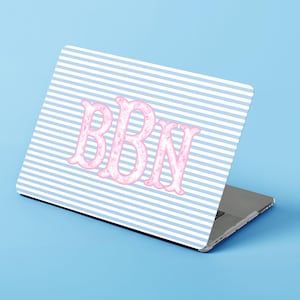 May include: A laptop skin featuring a pattern of thin horizontal white and light blue stripes. Centered on the skin are the large, stylized capital letters BBN in a light pink color with a subtle, marbled or textured appearance.