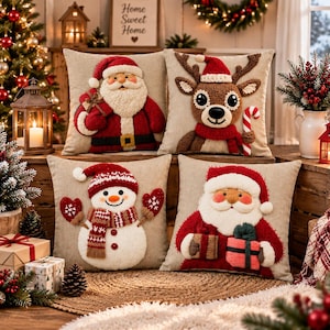 May include: Four square throw pillows with textured, raised holiday designs on a light beige fabric. The designs feature a Santa Claus with a gift sack, a reindeer with a candy cane, a snowman with red mittens, and a Santa Claus holding a gift.