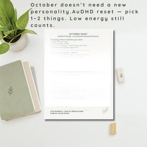 May include: A white planner page titled October Reset AuDHD-Friendly Low-Demand Seasonal Planner with an energy check-in list. The text reads: October doesn't need a new personality. AuDHD reset — pick 1-2 things. Low energy still counts.