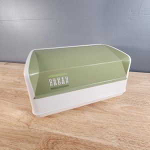 May include: A green and white bread box with the word "BREAD" printed on the front.