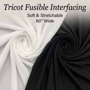 May include: Tricot Fusible Interfacing, soft and stretchable, 60 inches wide. The image displays two swatches of fabric, one white and one black, both arranged in a swirling, draped pattern to show the texture and flexibility of the material.
