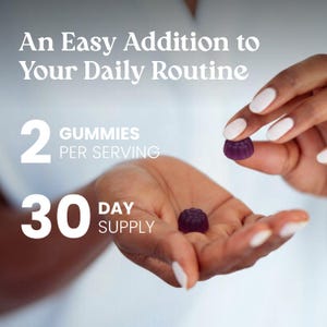 May include: Two small, dark purple, flower-shaped gummies. Text reads: An Easy Addition to Your Daily Routine, 2 GUMMIES PER SERVING, 30 DAY SUPPLY. The gummies have a textured, scalloped edge and a smooth, rounded top surface.