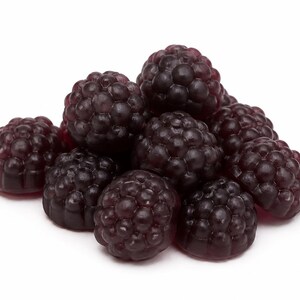 May include: A small pile of dark purple, translucent gummy candies shaped like blackberries. Each individual piece features a textured, bumpy surface that mimics the appearance of real fruit drupelets, with a glossy finish and deep violet color.