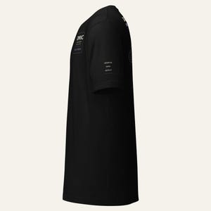 May include: A black short-sleeved t-shirt featuring white text on the chest that reads DMIC, DEEP WATER, FIELD CREW. On the sleeve, white text reads OBSERVE, INFER, REPEAT. The shirt is shown from a side profile view, displaying the sleeve and torso.