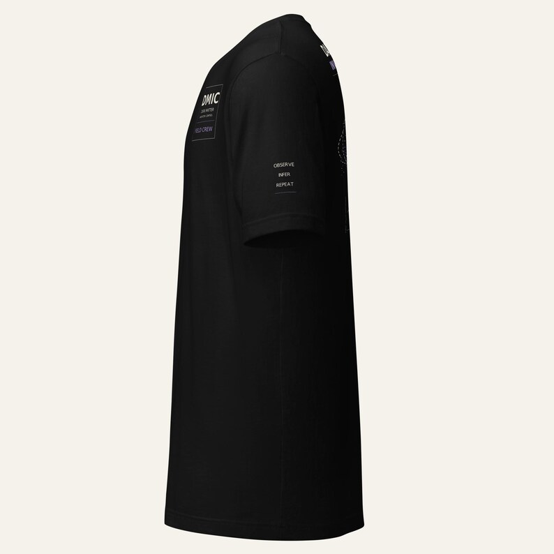 May include: A black short-sleeved t-shirt featuring white text on the chest that reads DMIC, DEEP WATER, FIELD CREW. On the sleeve, white text reads OBSERVE, INFER, REPEAT. The shirt is shown from a side profile view, displaying the sleeve and torso.