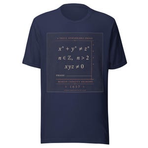 May include: A navy blue short-sleeve t-shirt featuring a square graphic with the text A TRULY REMARKABLE PROOF, mathematical equations including x^n + y^n &ne; z^n, n &isin; ℤ, n > 2, xyz &ne; 0, the word PROOF, MARGIN CAPACITY EXCEEDED, and 1637.