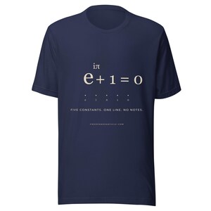 May include: A navy blue short-sleeve t-shirt featuring the mathematical equation e to the power of i times pi plus one equals zero in white text. Below the equation are five dots and the text FIVE CONSTANTS. ONE LINE. NO NOTES. PROOFANDPARTICLE.COM.