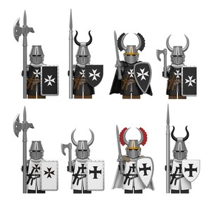 May include: Eight miniature knight figures arranged in two rows. Each figure wears a metallic helmet, some with horns or crests, and carries a shield featuring a cross emblem. They are equipped with various weapons including spears, axes, and swords.