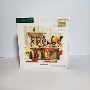 May include: A Department 56 Collectors' Edition box featuring The Regal Ballroom from the Christmas in the City series. The packaging displays a detailed miniature building with lit windows, a balcony with figures, and festive greenery.