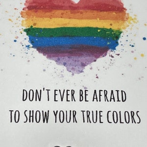 May include: A rainbow heart with the text "Don't ever be afraid to show your true colors" and a rainbow heart charm bracelet.
