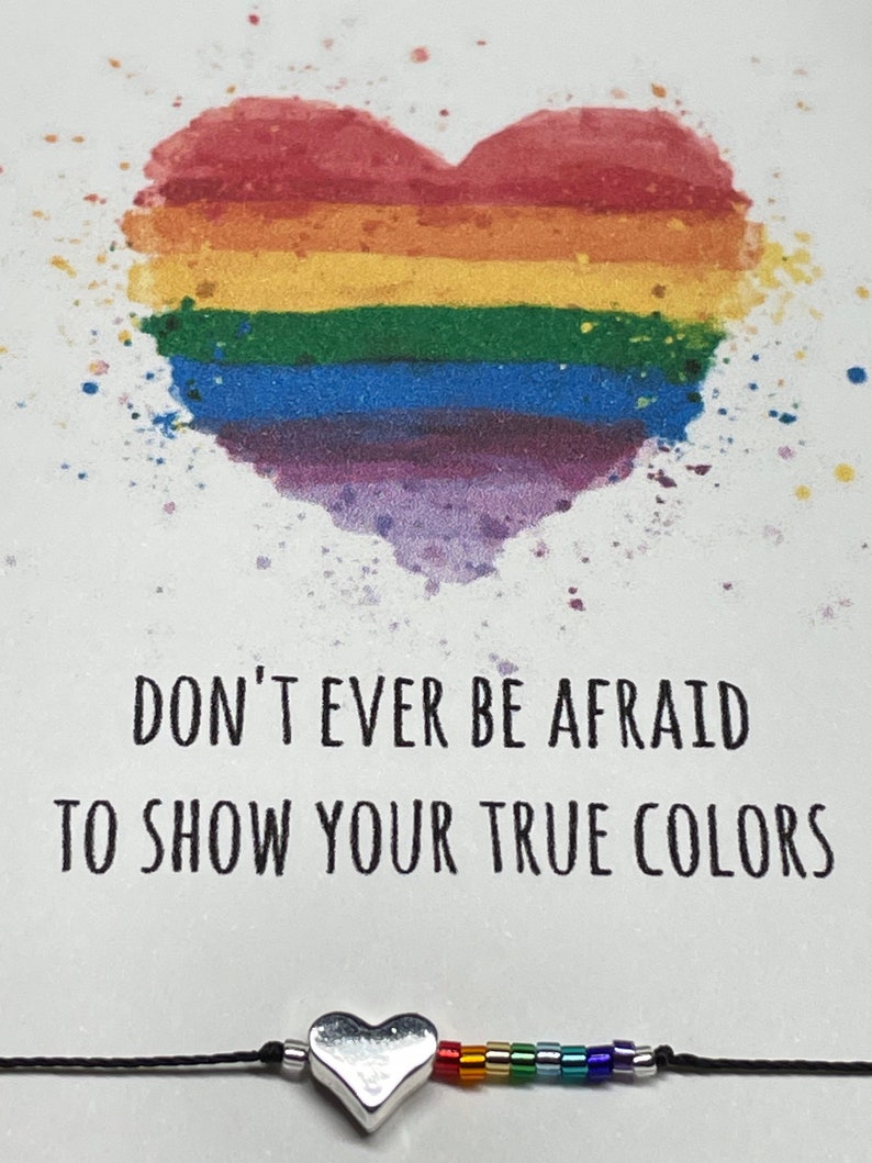May include: A rainbow heart with the text "Don't ever be afraid to show your true colors" and a rainbow heart charm bracelet.