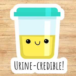 May include: A sticker featuring a cartoon urine sample container with a smiling face. The container is yellow with a teal lid and the text "Urine-Credible!" in black.