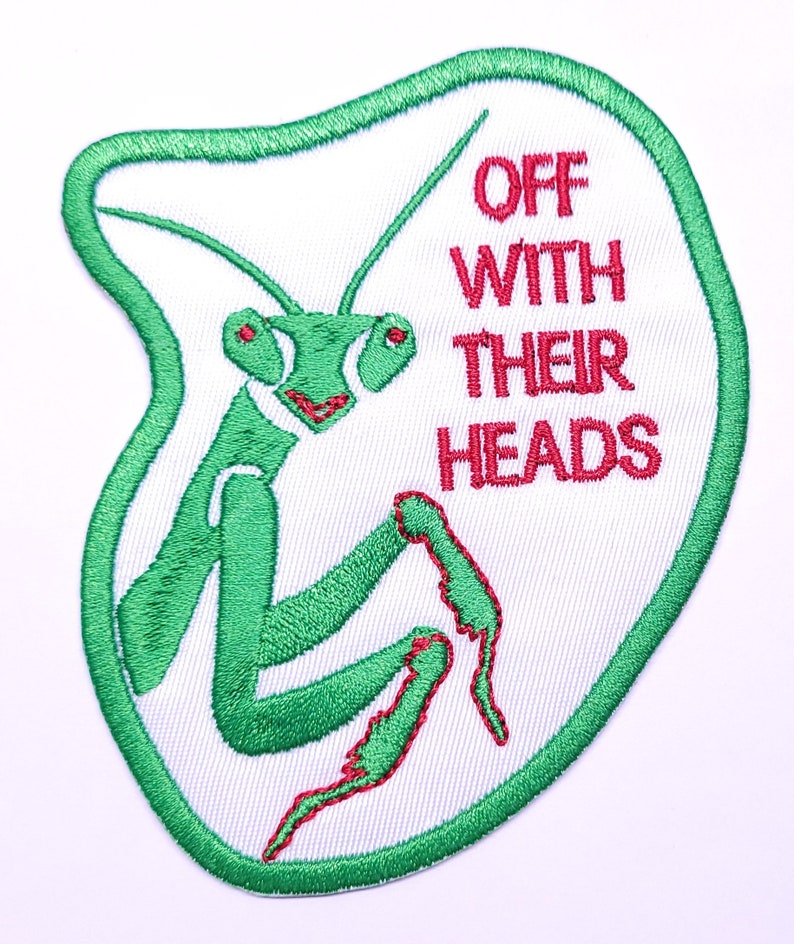 May include: Green embroidered patch with a praying mantis and the text "Off With Their Heads" in red.