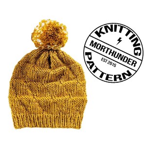 May include: A mustard yellow knitted beanie with a white and yellow pom pom on top. The beanie has a knitted pattern and is made with a soft yarn. The image also includes a black and white logo that says "Knitting Pattern" with the words "Morthunder" and "Est 2015" inside the logo.
