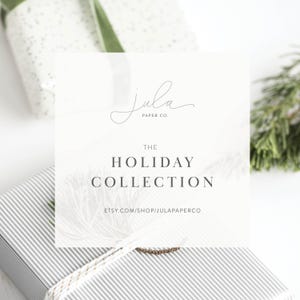 May include: A white and grey striped gift box with a white ribbon and a white card with the text "The Holiday Collection" and the website address "etsy.com/shop/julapaperco". The card also has the text "Jula Paper Co." in a cursive font.