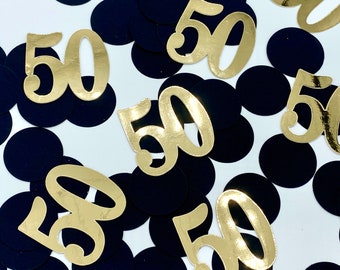 May include: Gold confetti with the number 50 on it. The confetti is scattered on a white background with black circles.