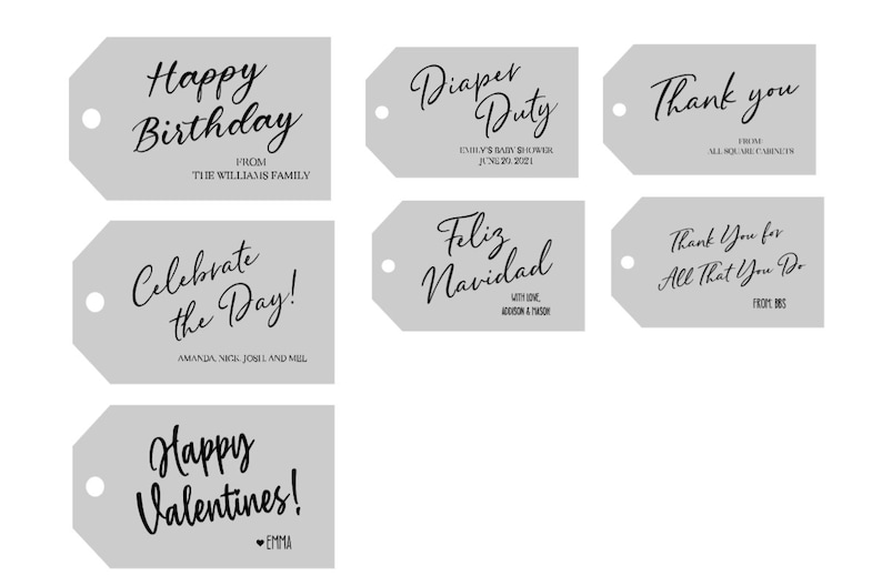 May include: Seven rectangular light gray gift tags with rounded corners and a circular hole on the left side. Each tag features black printed text in various fonts, including phrases like Happy Birthday, Diaper Duty, Thank you, Celebrate the Day, Feliz Navidad, Thank You for All That You Do, and Happy Valentines.