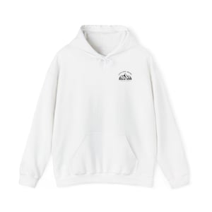 Puede incluir: Una sudadera blanca con capucha y manga larga, con un bolsillo tipo canguro en la parte delantera y un pequeño gráfico negro en la parte superior izquierda del pecho. El gráfico muestra una montaña con pinos y el texto "EXPLORE MORE" arriba y "WILD & FREE" abajo.