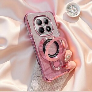 May include: A glittery pink smartphone case featuring a metallic camera lens frame and a circular ring stand on the back. The ring stand includes black text that reads colnel and emotion changes the world. The case has a textured, sparkling finish.