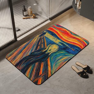 Peut inclure: Un tapis de sol rectangulaire arborant une impression multicolore vibrante du tableau Le Cri. Le motif présente des coups de pinceau tourbillonnants dans des tons orange, jaune, bleu et noir, représentant une figure centrale les mains au visage.