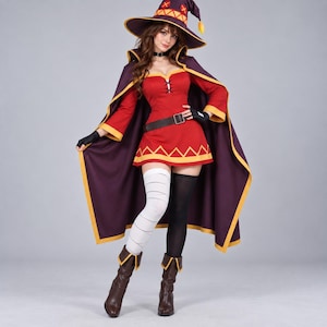 May include: A costume featuring a red dress with a lace-up bodice, a dark purple cape with yellow trim, and a matching pointed hat with yellow accents. The outfit includes one white thigh-high stocking with horizontal lines, one black stocking, and brown boots.