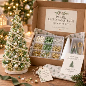 May include: A DIY craft kit for a pearl Christmas tree in a cardboard box. The kit includes a white cone, pliers, gold wire, and a divided container with green, white, and gold beads and charms. A finished beaded tree stands beside the box.