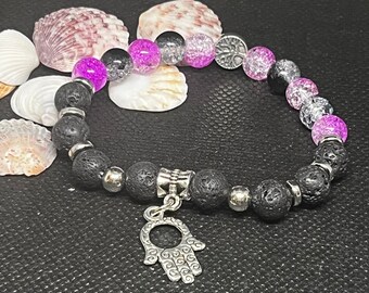 Crackled Quartz & lava stone diffuser Bracelet 7”. Black and pink crackled quartz beads with silver spacers and hamsa, tree of life charm.