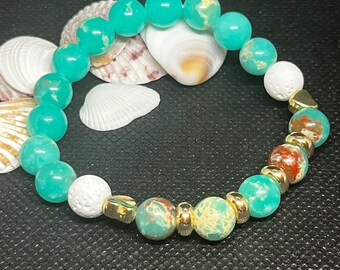 Imperial Jasper Beaded 7” Diffuser Bracelet with White Lava stone with gold toned round and heart shaped spacers. Stacked bracelet.