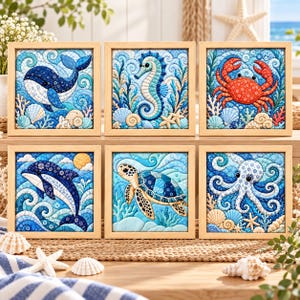 May include: A set of six square framed wall art pieces featuring quilted-style illustrations of a whale, seahorse, crab, dolphin, sea turtle, and octopus. Each image displays vibrant blue ocean waves, coral, and seashells in a detailed pattern.