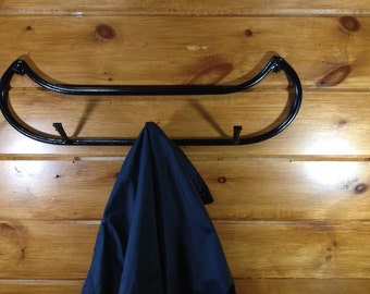 A pair of 3 Hook Canoe Shaped Jacket / Hat Racks, a pair of canoe towel racks with bars and One Canoe Toilet paper holder