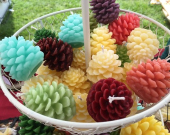 Qty of 4 Small colored pinecone beeswax candle. Yellow beeswax with color added.2-1/2 inches tall x 1-1/2 inches wide.