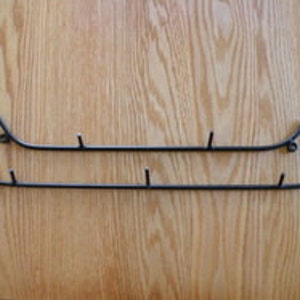 May include: Black metal canoe-shaped wall hook with five hooks.