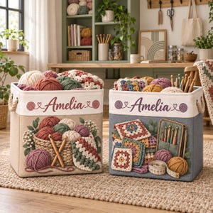 May include: Two square fabric storage bins with rope handles, each personalised with the name Amelia. The left bin features a basket of yarn balls and crochet hooks. The right bin displays colourful granny squares, a hook case, and a measuring tape.