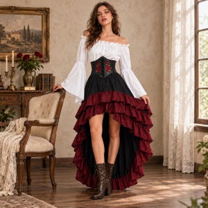 May include: A white off-the-shoulder blouse with long flared sleeves, a black corset-style bodice featuring red rose embroidery and lace-up detailing, and a high-low skirt with a black base and layered burgundy ruffled trim, paired with brown boots.