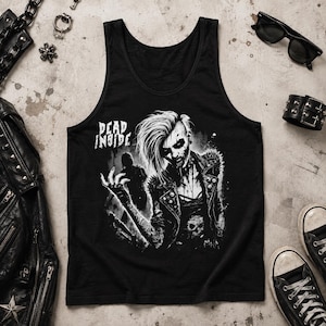 May include: A black vest top featuring a white graphic print of a person with spiky hair and a studded jacket. The text "DEAD INSIDE" is printed in white above the figure. The design includes detailed shading and a skull motif on the lower section.