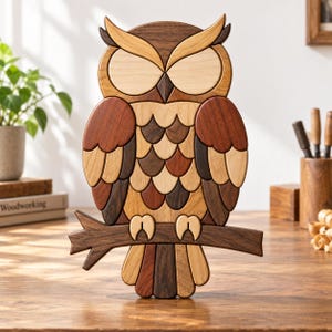 May include: A decorative owl figurine crafted from various shades of natural wood. The owl features layered, scalloped wing and chest feathers in light, medium, and dark brown tones, perched on a dark brown wooden branch with closed eyes.